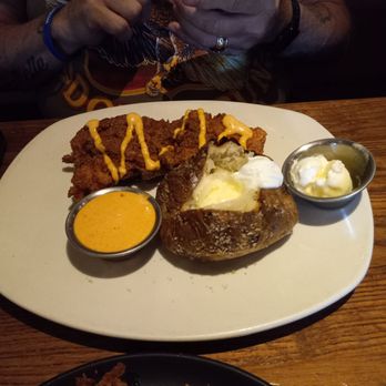 Outback Steakhouse - My hubby's Bloomin' Fried Chicken with his Baked Potato with butter and sour cream. - Steakhouses Near Me - Inverness, Florida