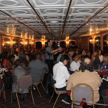 The Dinner Detective - a large group of people sitting at tables - Dinner Theater Near Me - Chapel Hill, North Carolina The Dinner Detective - a large group of people sitting at tables - Dinner Theater Near Me - Chapel Hill, North Carolina