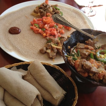 Ethiopic - Ethiopic Signature Tibs- Lamb served with salad and injera bread - Ethiopian Near Me - Washington, DC, District of Columbia