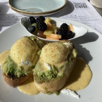 Sixty Vines - Avocado Eggs Benedict. Comes with a side of fruit. - New American Near Me - Plano, Texas Sixty Vines - Avocado Eggs Benedict. Comes with a side of fruit. - New American Near Me - Plano, Texas