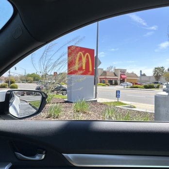 McDonald's - a view of a mcdonald's sign through a car window - Burgers Near Me - Kerman, California McDonald's - a view of a mcdonald's sign through a car window - Burgers Near Me - Kerman, California
