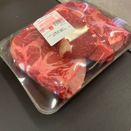 a piece of beef wrapped in plastic a piece of beef wrapped in plastic