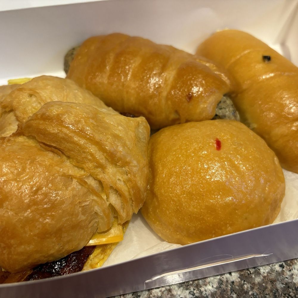 Left to Right (clockwise) BEC Croissant Sandwich, Boudin Kolache, Jumbo Sausage and Cheese Kolche, Smoked Brisket Kolache