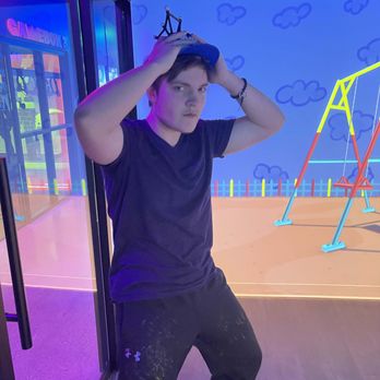 Immersive Gamebox - Very cool looking teenager kiddo modeling the visor/sensor thing - Virtual Reality Centers Near Me - Louisville, Kentucky