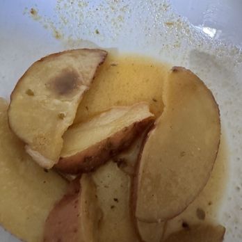 Taso's Greek Taverna - Rotten, under cooked lemon potatoes.  Flavorless. - Greek Near Me - Delray Beach, Florida