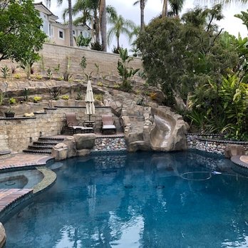 Alan Smith Pool Plastering & Remodeling - Day time photo of resurfaced pool, redesigned spa and newly constructed waterslide and waterfall. - Pool & Hot Tub Service Near Me - Orange, California