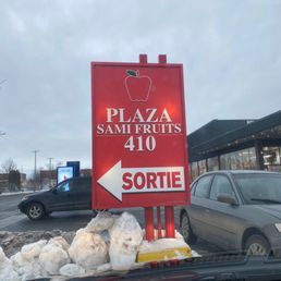 a red sign in a parking lot a red sign in a parking lot