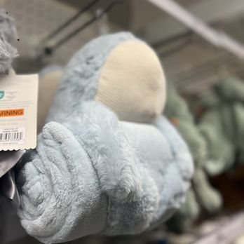Target - A soft, plush stuffed animal in light blue with a cream-colored face and paws, displayed on a store shelf among other toys. - Department Stores Near Me - Temecula, California
