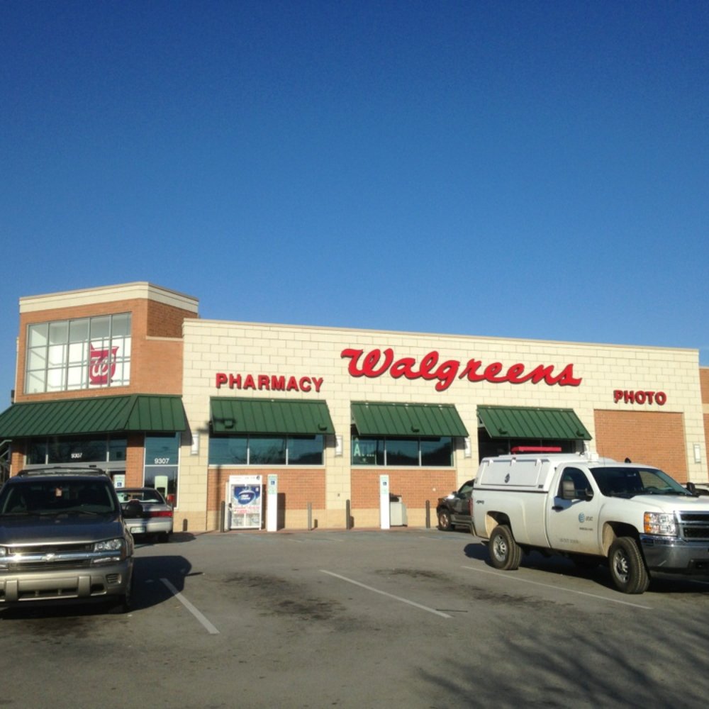 two trucks parked in front of a walgreens pharmacy two trucks parked in front of a walgreens pharmacy