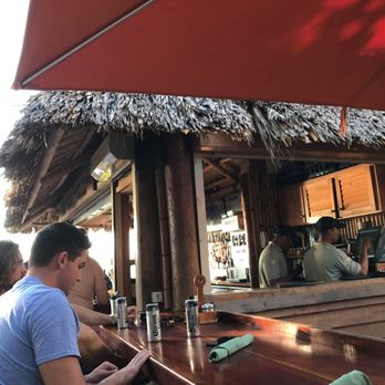 Sandbar - a group of people sitting at a bar - New American Near Me - Naples, Florida Sandbar - a group of people sitting at a bar - New American Near Me - Naples, Florida