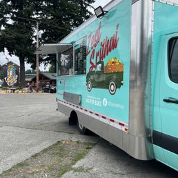 a food truck parked in a parking lot a food truck parked in a parking lot