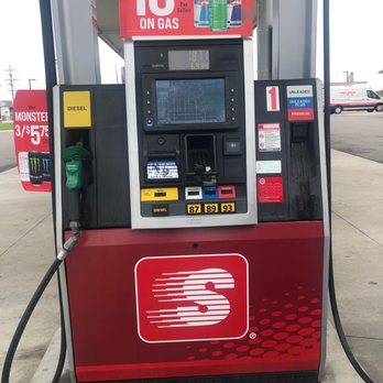 Speedway - a red gas pump with a sign that says buy 3 save on gas - Fuel pump at Speedway gas station displaying fuel prices, including regular, plus, and premium options. Promotional signage above advertises a discount on gas when buying three Red Bull cans. The pump features a digital screen, card reader, and fuel selection buttons. The station's logo is prominently displayed on the lower part of the pump, and additional signage for Monster energy drinks is visible in the background. - Gas Stations Near Me - Avon, Ohio