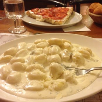 Woodstock 3 - Gnocchi (4 cheese) and a small slice of salami pizza in the back. - Italian Near Me - Milan, Michigan Woodstock 3 - Gnocchi (4 cheese) and a small slice of salami pizza in the back. - Italian Near Me - Milan, Michigan
