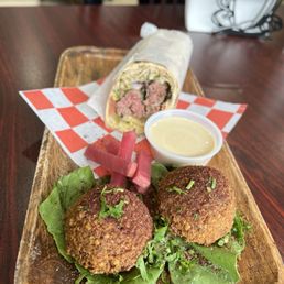 Kafta kebab sandwich with a side of two falafels.