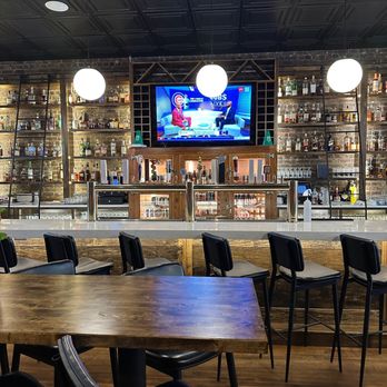 Pizza Beer Whiskey - A look at the bar - you can see the beer taps under the TV.  The liquor is organized in sections - whiskey on the right. - Pizza Near Me - Sycamore, Illinois