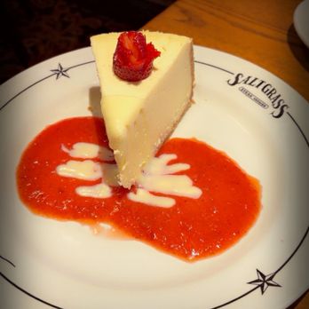 Saltgrass Steak House - Cheesecake with strawberry sauce & white chocolate drizzle - Steakhouses Near Me - Grapevine, Texas Saltgrass Steak House - Cheesecake with strawberry sauce & white chocolate drizzle - Steakhouses Near Me - Grapevine, Texas
