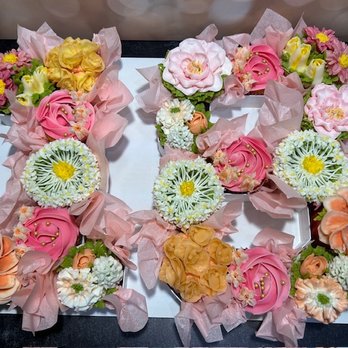 Inspired Frosts - Number box shaped as "18" filled with custom cupcakes--celebrating a milestone birthday with sweet style and buttercream blooms. - Custom Cakes Near Me Inspired Frosts - Number box shaped as "18" filled with custom cupcakes--celebrating a milestone birthday with sweet style and buttercream blooms. - Custom Cakes Near Me