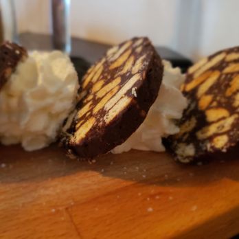 Santa Panza - three cookies on a cutting board with whipped cream - Pizza Near Me - Brooklyn, New York