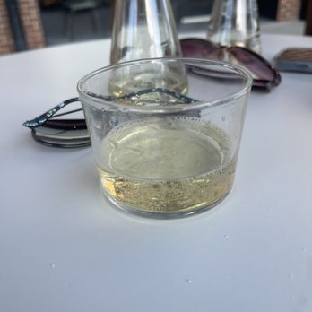 Que Gusto - Glasses of wine under the pergola on the patio at que gusto - Latin American Near Me - Tulsa, Oklahoma