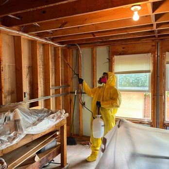 Ensign Building Solutions - Ensign crew member fully clothed in PPE remediating mold in a basement caused by high relative humidity over period of time. - Damage Restoration Near Me - Cumming, Georgia