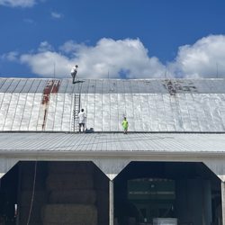 Kerrigan Painting & Power Washing - Preparing to paint a barn roof