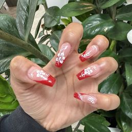 Gel-X red french tip with floral and line design Gel-X red french tip with floral and line design