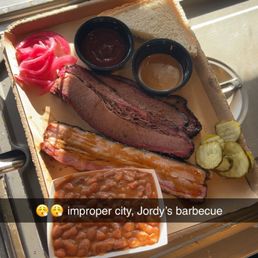 This plate has some pork belly and brisket from Jordy's barbecue along with some of their side beans This plate has some pork belly and brisket from Jordy's barbecue along with some of their side beans
