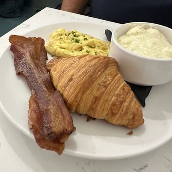 The Brewpaddle Cafe - Scrambled eggs bacon grits and buttery croissant - Breakfast & Brunch Near Me - Biloxi, Mississippi The Brewpaddle Cafe - Scrambled eggs bacon grits and buttery croissant - Breakfast & Brunch Near Me - Biloxi, Mississippi