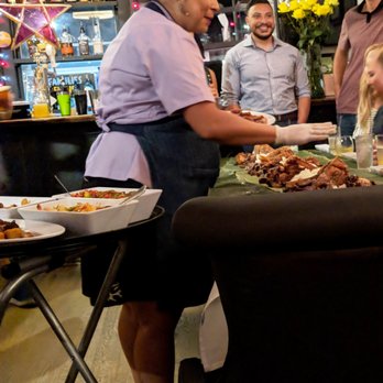 Purple Patch - Patrice Cleary presiding over a traditional banquet/feast (?) for a birthday party at the next table - Filipino Near Me - Washington, DC, District of Columbia