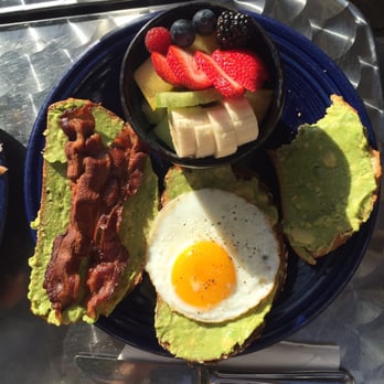 Eight AM - Three way avocado toast one sunny side up. One with bacon and one with heirloom tomatoes. Delish! - New American Near Me - San Francisco, California Eight AM - Three way avocado toast one sunny side up. One with bacon and one with heirloom tomatoes. Delish! - New American Near Me - San Francisco, California