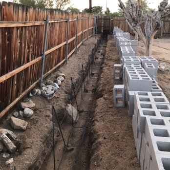 RD Taylor General Contractor - concrete blocks lined up along a fence - General Contractors Near Me RD Taylor General Contractor - concrete blocks lined up along a fence - General Contractors Near Me