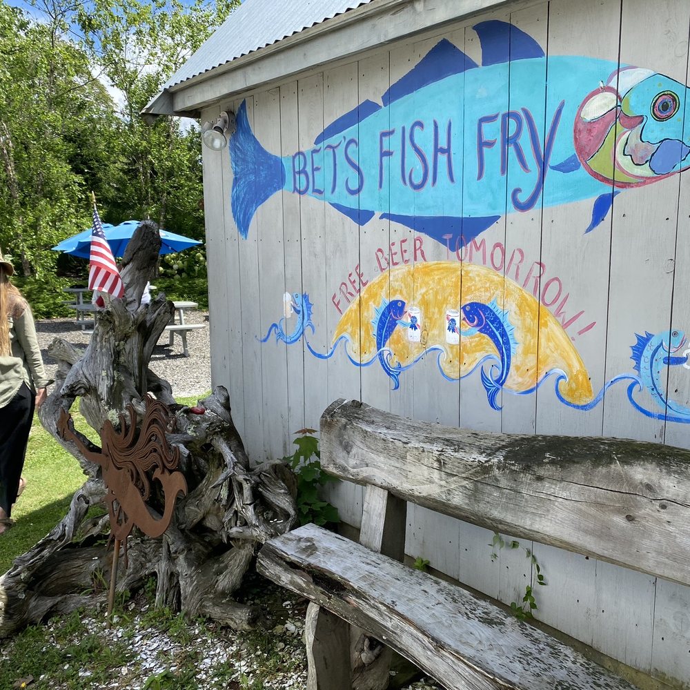 Bet's Fish Fry - a woman walking in front of a building - Seafood Near Me - Boothbay, Maine Bet's Fish Fry - a woman walking in front of a building - Seafood Near Me - Boothbay, Maine