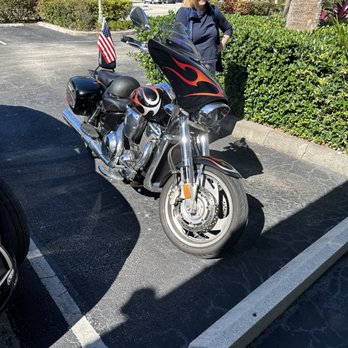 Buffalo Chophouse - a woman standing next to a motorcycle - Steakhouses Near Me - Port Saint Lucie, Florida