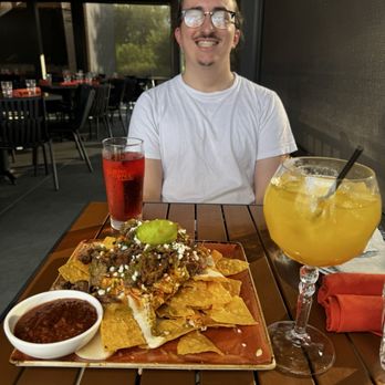 Grindstone on the Monon - Loaded nachos and margaritas on the patio at Grindstone on the Monon! Perfect little spot for drinks and apps. - New American Near Me - Westfield, Indiana Grindstone on the Monon - Loaded nachos and margaritas on the patio at Grindstone on the Monon! Perfect little spot for drinks and apps. - New American Near Me - Westfield, Indiana