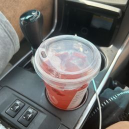 a drink in a plastic cup in a car a drink in a plastic cup in a car