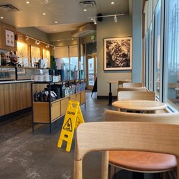 a coffee shop with a caution sign in the foreground a coffee shop with a caution sign in the foreground