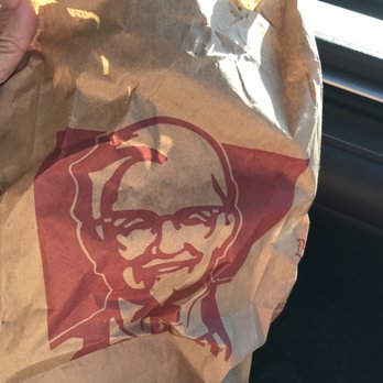 KFC - a hand holding a paper bag with a kfc logo on it - Chicken Shop Near Me - London, Ontario KFC - a hand holding a paper bag with a kfc logo on it - Chicken Shop Near Me - London, Ontario