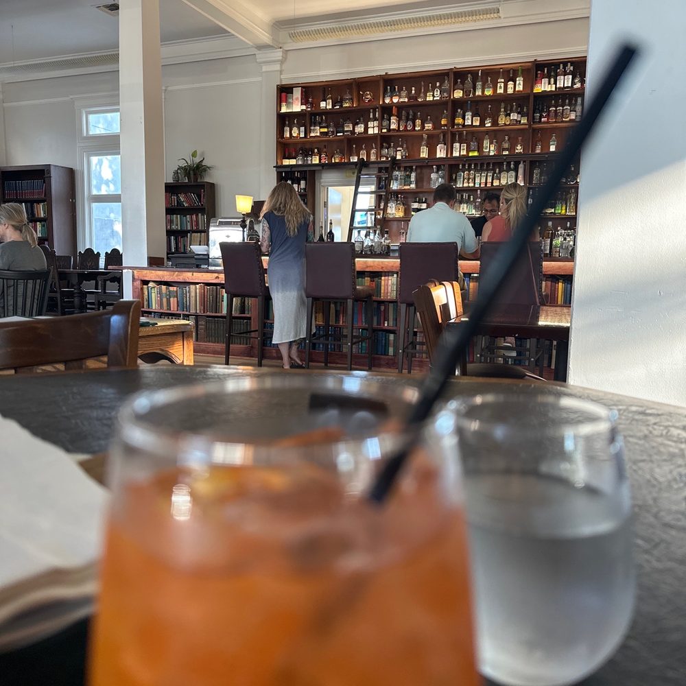 The Library - a glass of orange juice with a straw - Bars Near Me - Vacaville, California The Library - a glass of orange juice with a straw - Bars Near Me - Vacaville, California