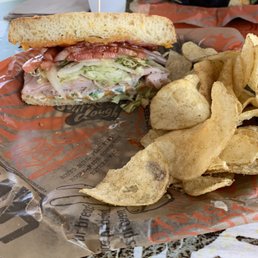 The spicy turkey bbq bacon smoke cheesy sandwich and chips The spicy turkey bbq bacon smoke cheesy sandwich and chips