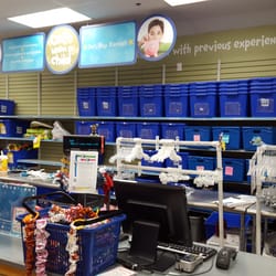 Once Upon A Child - Checkout counter, one blue bin for each customer.