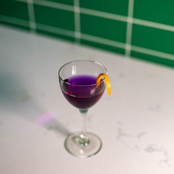Dive - a purple drink in a wine glass - Cocktail Bars Near Me - Eau Claire, Wisconsin Dive - a purple drink in a wine glass - Cocktail Bars Near Me - Eau Claire, Wisconsin