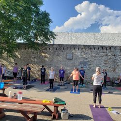 Dirty Girl Adventures - Compass Point - Compass Point RYT, Jen Sieben, begins a peaceful yoga class in the courtyard at Compass Point.