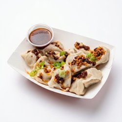 Boiled dumplings with house made chili sauce topped with green onions & fried onion. A burst of umami flavors in each bite!
