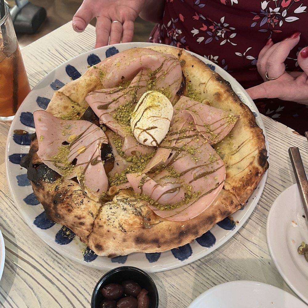 Focaccia Mortadella Pizza Focaccia with mortadella, fresh burrata cheese, and pistachio pesto Focaccia Mortadella Pizza Focaccia with mortadella, fresh burrata cheese, and pistachio pesto