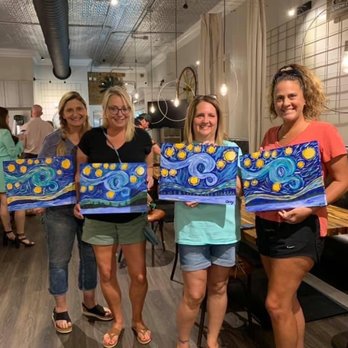 Square Roots - a group of women holding paintings - American Near Me - Eutaw, Alabama Square Roots - a group of women holding paintings - American Near Me - Eutaw, Alabama