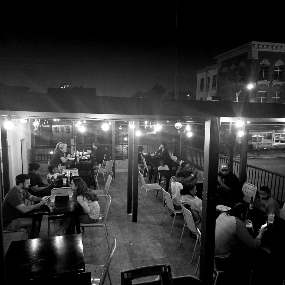Burger Bodega - Upstairs patio on a Saturday night! - Burgers Near Me - Houston, Texas