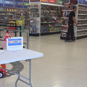 Toys R Us - The guy in background was the rude one.  And the sign shows no bags etc. - Toy Stores Near Me - Long Beach, California