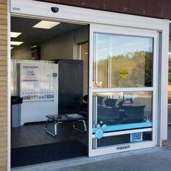 The Washery Laundry - Large automatic door located in parking lot.