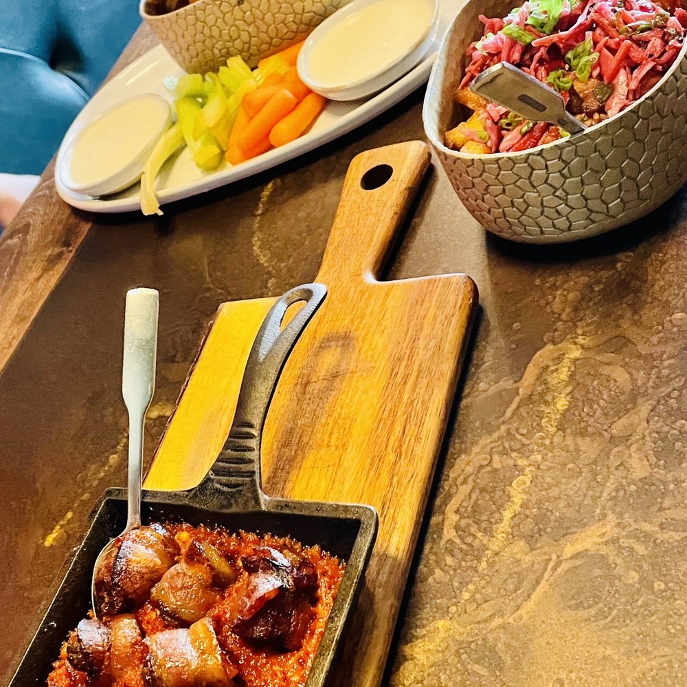 Appetizers: Bacon-wrapped dates, pork belly and rice and peri-peri chicken wings. Appetizers: Bacon-wrapped dates, pork belly and rice and peri-peri chicken wings.