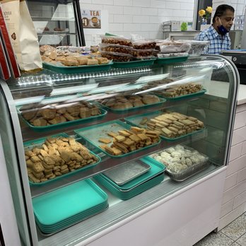 Virasat Cafe - a man behind a bakery counter - Indian Near Me - Queens, New York Virasat Cafe - a man behind a bakery counter - Indian Near Me - Queens, New York